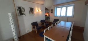 a room with a table and chairs and a window at Les chambres du Ladoux in Puy-de-Fourches