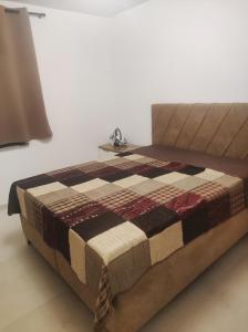 a bed sitting in a room with a table at Attraktive Neubauwohnung in Bremen