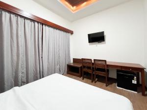 Μια τηλεόραση ή/και κέντρο ψυχαγωγίας στο Urbanview Hotel Arta Guna Casa
