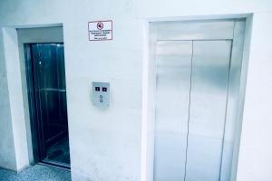 an elevator in a building with a sign on the wall at Stylish 2 Bedroom! Heart of city!! in Yerevan +2 photos