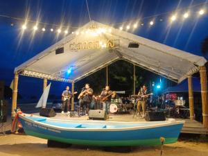 a band playing on a boat on the beach at Baan Raweewan Resort in Ban Phu Yai
