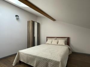 a bedroom with a bed in a white room at newTown City Center Apartment Kaunas in Kaunas