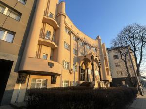 a large building with a staircase in front of it at newTown City Center Apartment Kaunas in Kaunas