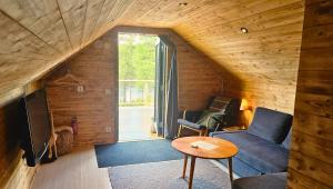 a living room with a couch and a table at Cozy River Cabin Styled Loft in Kiruna