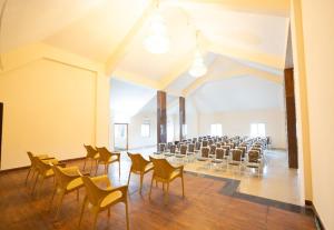 an empty room with chairs and tables in it at MSB Silver Spring Resort in Yelagiri