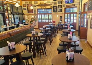 a restaurant with tables and chairs and a bar at The Grand Hotel Cairns in Cairns +7 photos
