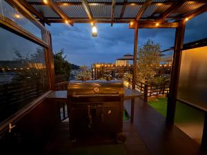 a grill on a balcony with a view of the city at リゾートヴィラ宮島 Sunset terrace in Hatsukaichi