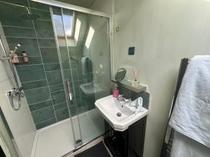 ein Badezimmer mit Waschbecken und Dusche in der Unterkunft Upper Barn at the Flax Mill in Coleraine + 15 Fotos