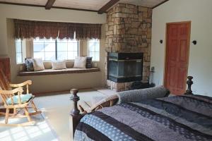 ein Schlafzimmer mit einem Kamin, einem Bett und einem Sofa in der Unterkunft Beautiful Big Bear Lake Retreat in Big Bear Lake