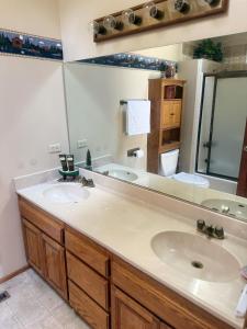 ein Badezimmer mit zwei Waschbecken und einem großen Spiegel in der Unterkunft Beautiful Big Bear Lake Retreat in Big Bear Lake