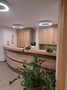 an office lobby with a reception counter with wooden cabinets at Hotel Gasthof Schützen GbR in Laupheim