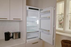 a white refrigerator with its door open in a kitchen at City Stay Vienna – Stephansdom in Vienna