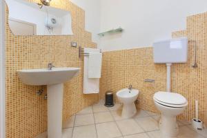 a bathroom with a toilet and a sink at Tenuta Gianfredi by BarbarHouse in Casarano +37 photos