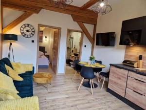 a living room with a couch and a table at Apartament MILKA 2 in Tolkmicko