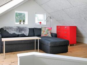 a living room with a couch and a red cabinet at 4 star holiday home in Børkop in Børkop