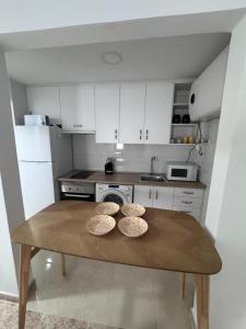 a kitchen with a table with three bowls on it at Alma azul in Puerto de Mazarrón