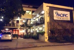 a car parked in front of a building at night at Pacific Palm Suites Davao powered by Cocotel in Davao City