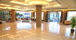 a lobby of a building with columns and chairs at Al Quba Palace Serviced Apartments in Riyadh