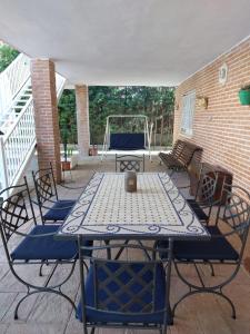 a patio with a table and chairs and a playground at Casa Rural El Raso in Almoguera