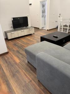 a living room with a couch and a flat screen tv at Apartament Albania in Tirana