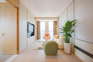 a living room with a couch and a chair at 融域公寓-南京博览中心店 in Nanjing