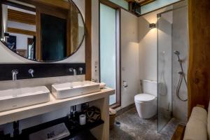 a bathroom with a sink and a toilet and a mirror at Bloom Resort Bali by BaliSuperHost in Canggu +28 photos