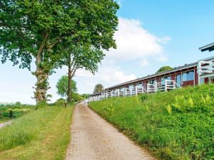 a dirt road in front of a building at 6 person holiday home in Aabenraa in Aabenraa