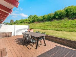 a picnic table and chairs on a brick patio at 6 person holiday home in Aabenraa in Aabenraa