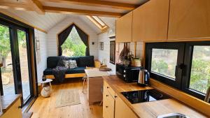 a kitchen and living room of a tiny house at La Vista Huma by Tiny Away in Alora