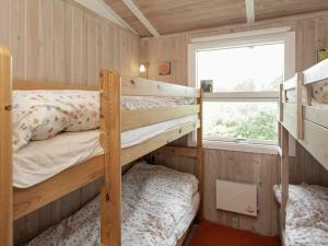 two bunk beds in a small room with a window at 4 person holiday home in Højslev in Højslev +16 photos