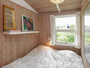 a bedroom with a bed and two windows at 4 person holiday home in Højslev in Højslev