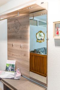 a dressing room with a mirror on a counter at Ferienwohnung Naturpur in Rheinau +13 photos