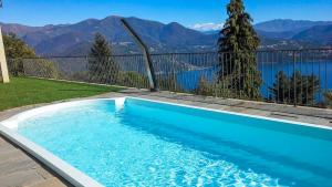 a swimming pool with a view of the mountains at Perla del Lago in Carmine