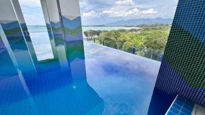 a view of a building with a swimming pool at Luxury, Cosy Seaview 1 bed Suite near SICC, Cuckoo in Kota Kinabalu