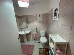 a small bathroom with a toilet and a sink at Traditional Peniche House in Peniche +7 photos