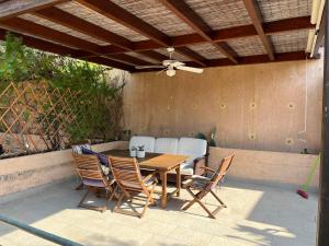 a wooden table and chairs on a patio at Daphne Glyfada Corfu in Glyfada