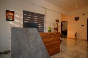 a lobby with a reception desk and a window at Green Pearl Residency in Kaniyapuram