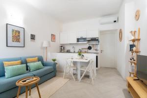 a living room with a blue couch and a table at Cozy 1 BDR - Downtown Milan Navigli, Duomo in Milan