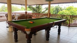 a pool table sitting on a porch with a deckledged at Villa Oranje Chiang Mai in Chiang Mai
