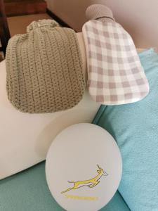 a hat and a white ball on a table at Somerset Grace Cottage in Somerset West +21 photos