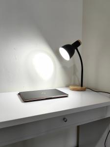 a laptop sitting on a white desk with a lamp at Setapak Central Mall KL - Zetapark Garden Suites in Kuala Lumpur +17 photos