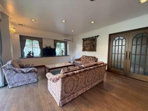 a living room with two couches and a table at Sea SIDE TERRACE in Toba
