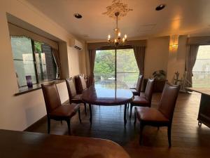 a dining room with a table and chairs and a window at Sea SIDE TERRACE in Toba