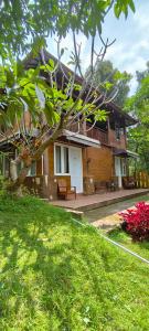 a house with a tree in front of it at NK Villa Syariah And Cafe Prigen in Pasuruan