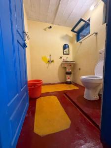 a bathroom with a toilet and a sink at The Himalayan Heaven Homestay, Binsar in Binsar
