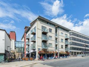 a large white building on a city street at Pass the Keys Oxford Castle - City Centre Apartment Balcony in Oxford
