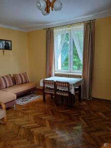 Una sala de estar con una mesa y una ventana. en Kawalerka Sikorskiego, en Kraśnik