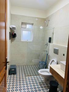un bagno con doccia, WC e lavandino di Vaayu Villa by Saanjh Stays a Rāmgarh Altre 18 foto