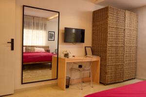 a room with a desk and a mirror and a bedroom at Serenity Room, Design House in Lagos +5 photos