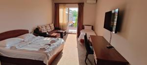 a living room with a couch and a flat screen tv at Areg Hotel in Yerevan